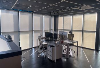 Modern San Ramon office with high quality pull down roller sheer shades installed on expansive glass doors, offering privacy and sunlight control.