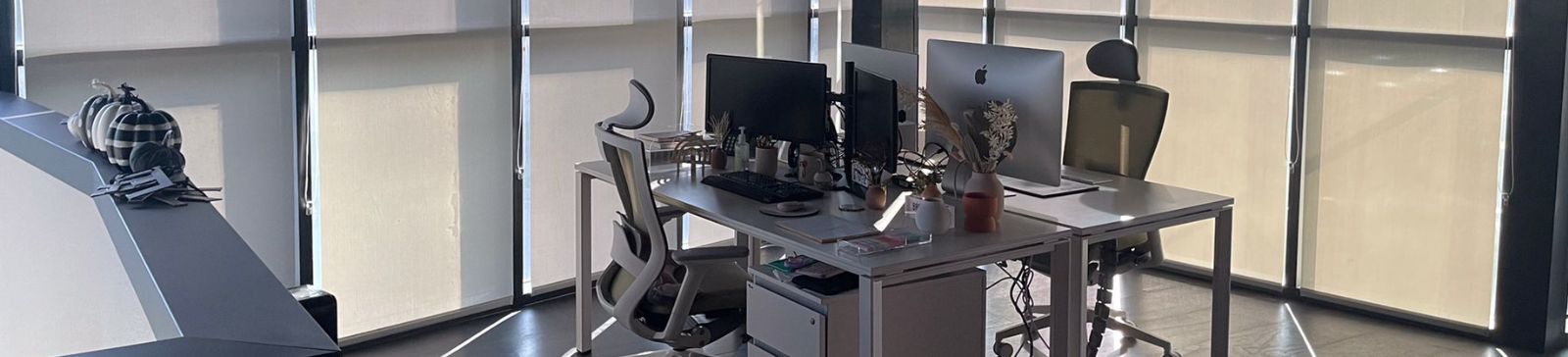 Sleek workstation setup in a San Ramon office surrounded by custom roller shades for windows, providing a comfortable and glare-free work environment.