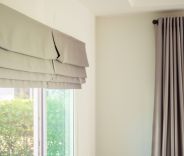 Bedroom window with Roman shades